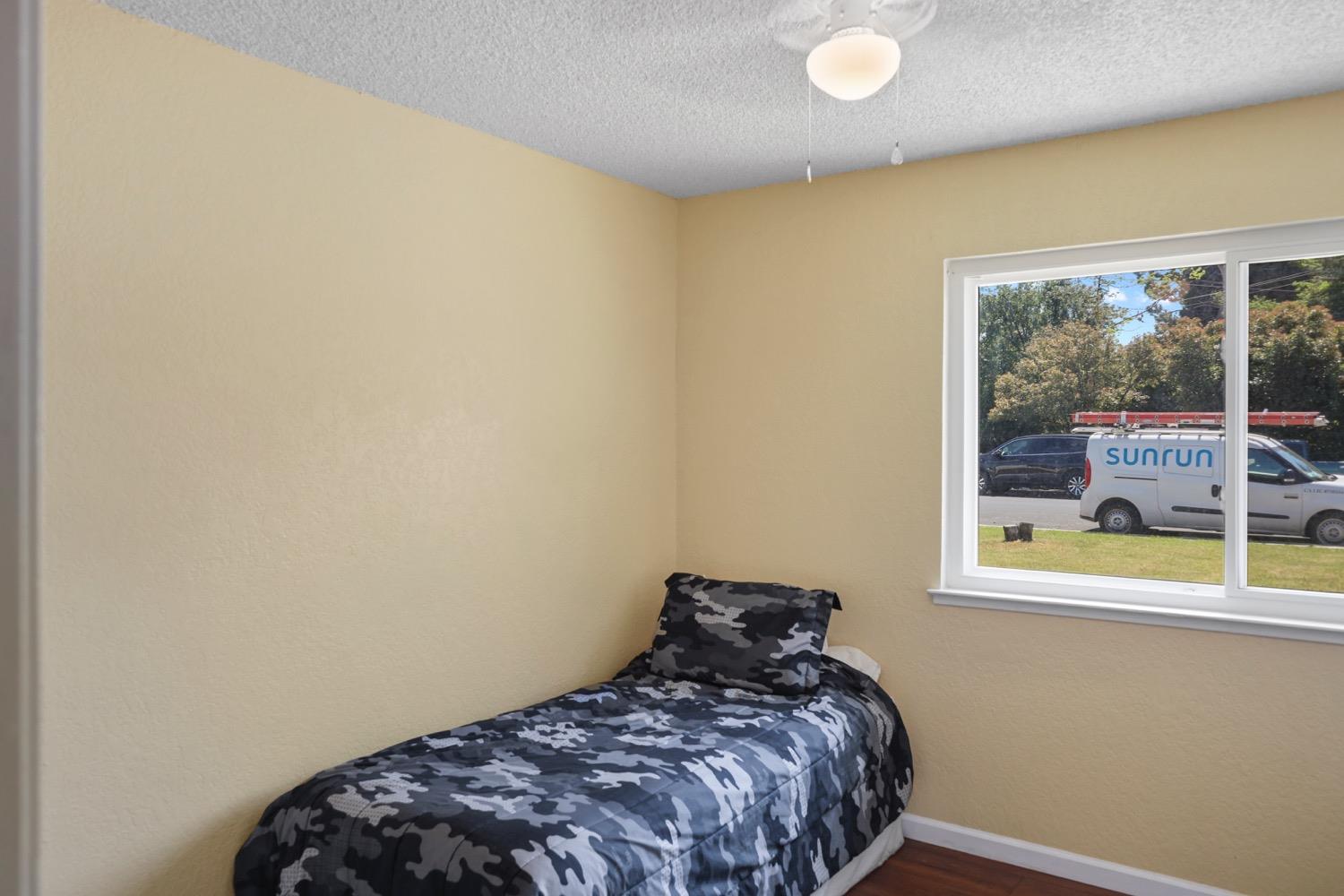 948 Harvard Avenue Clovis, CA 93612 - Photo 14 of 26 a bedroom with a bed and a painting on the wall