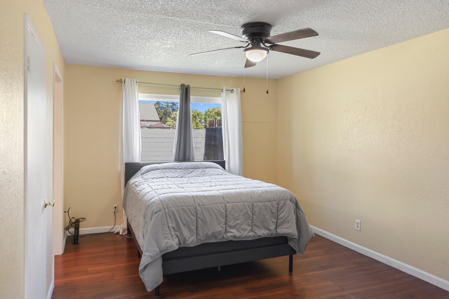 948 Harvard Avenue Clovis, CA 93612 - Photo 16 of 26 a bedroom with a bed and a large window
