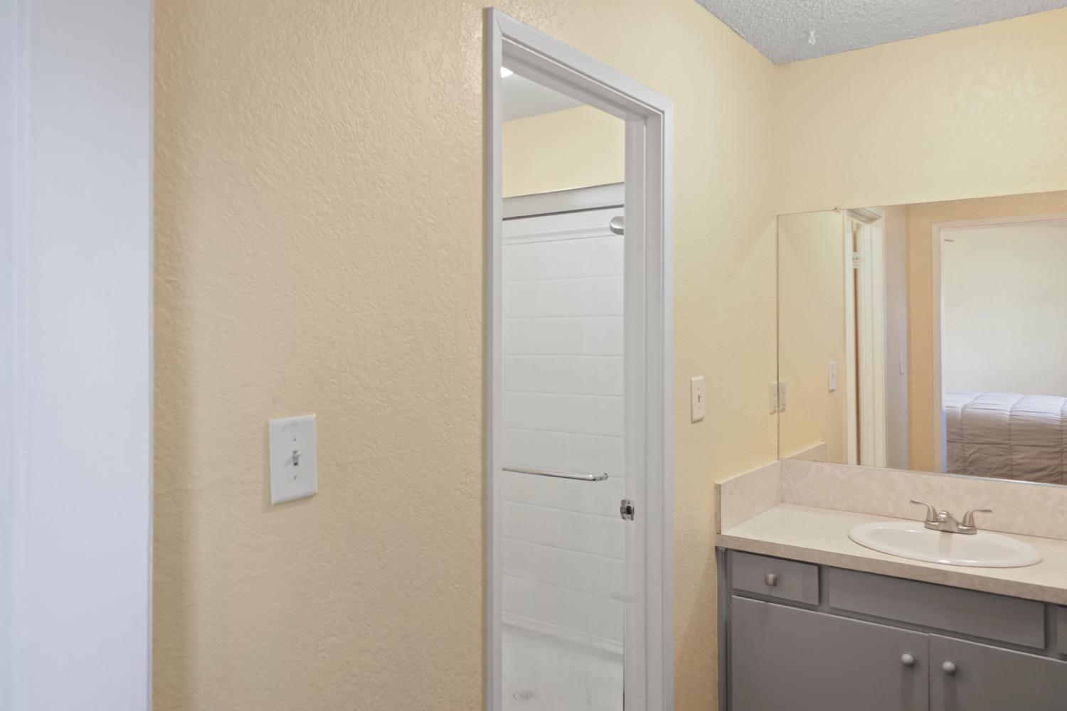 948 Harvard Avenue Clovis, CA 93612 - Photo 20 of 26 a bathroom with a sink and a mirror
