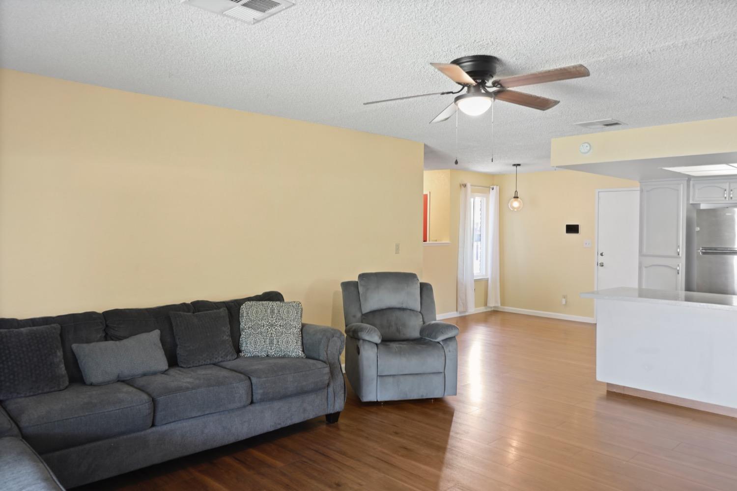 948 Harvard Avenue Clovis, CA 93612 - Photo 6 of 26 a living room with furniture and a wooden floor