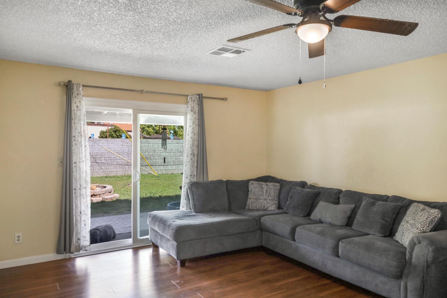 948 Harvard Avenue Clovis, CA 93612 - Photo 7 of 26 a living room with furniture and a large window