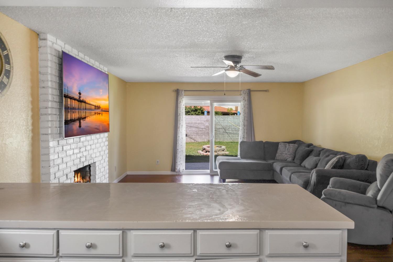 948 Harvard Avenue Clovis, CA 93612 - Photo 8 of 26 a living room with furniture and a fireplace