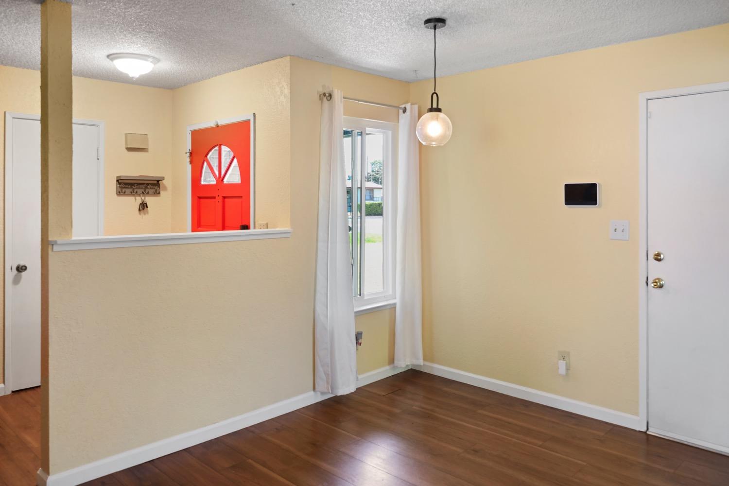 948 Harvard Avenue Clovis, CA 93612 - Photo 9 of 26 a view of an empty room with wooden floor and windows