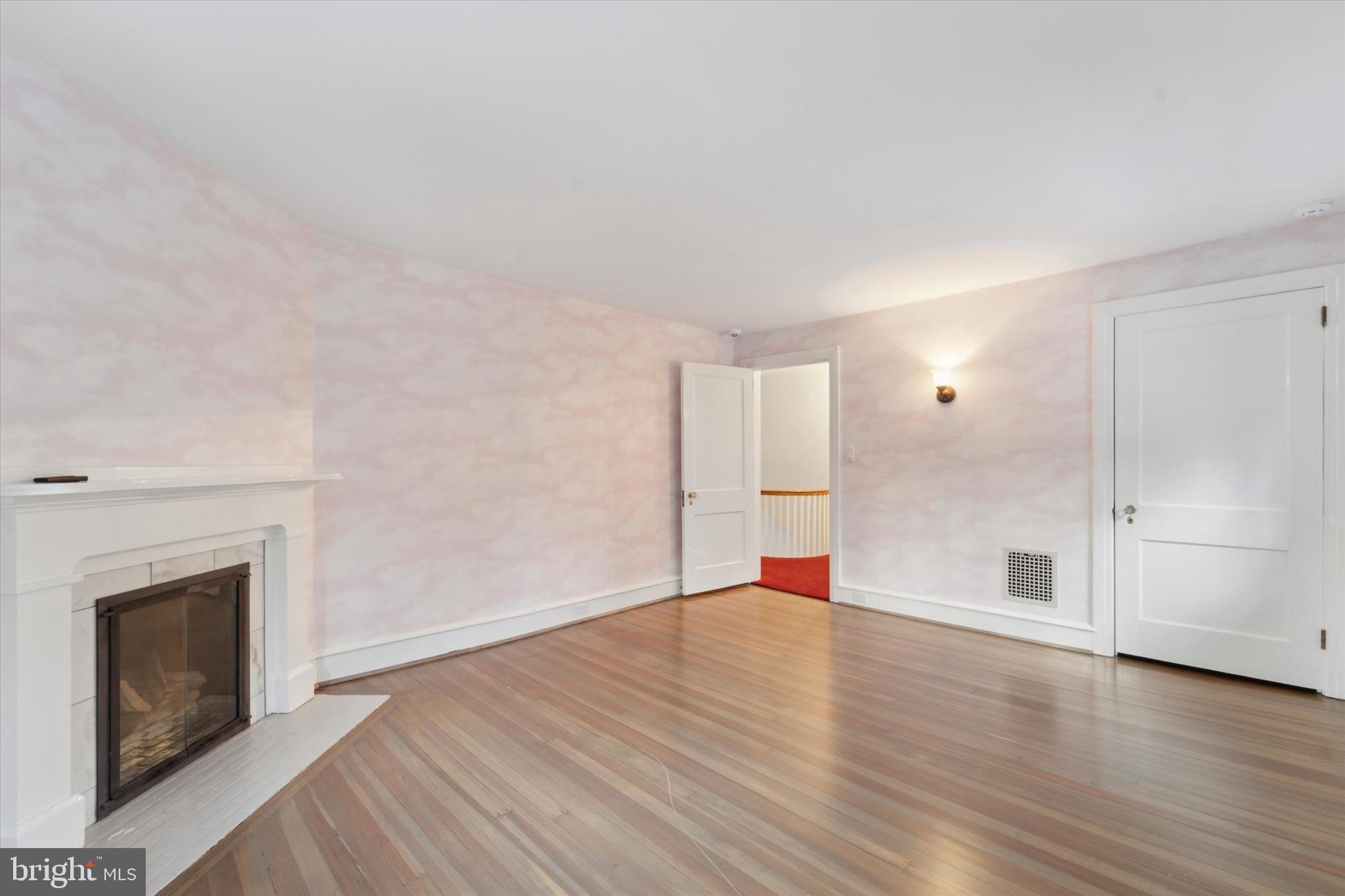 101 East Brookhaven Road Wallingford, PA 19086 - Photo 20 of 60 wooden floor in an empty room with a fireplace