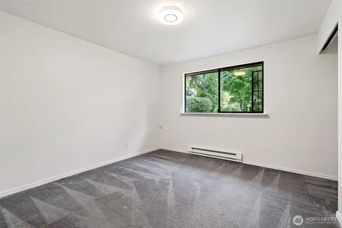 a view of a room with a window and a bed