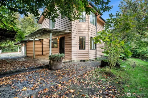 a view of a small house with potted plants