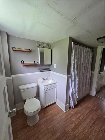 a bathroom with a toilet a sink and a shower