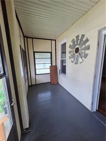 a view of a livingroom with an empty space and a window