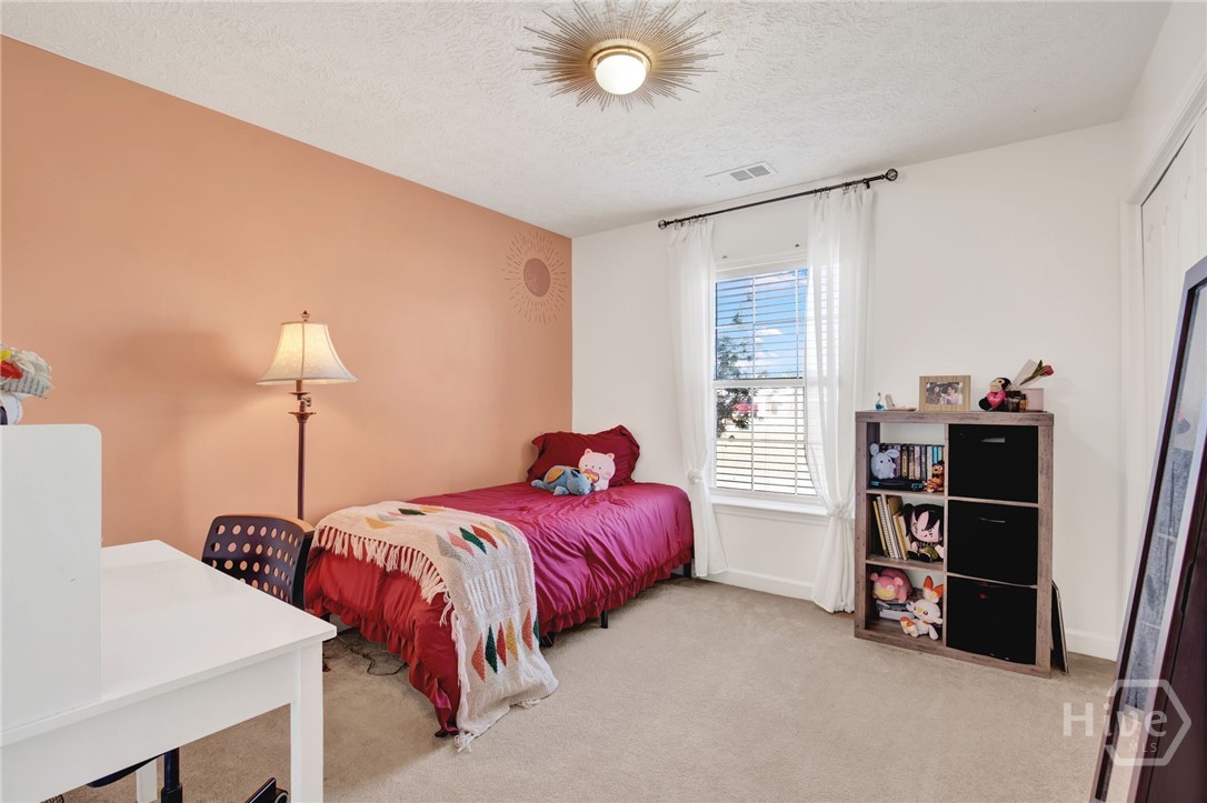 253 Scuffletown Road Guyton, GA 31312 - Photo 14 of 37 Bright and inviting bedroom featuring ample natural light and flexible space for a guest room, nursery, or workspace.