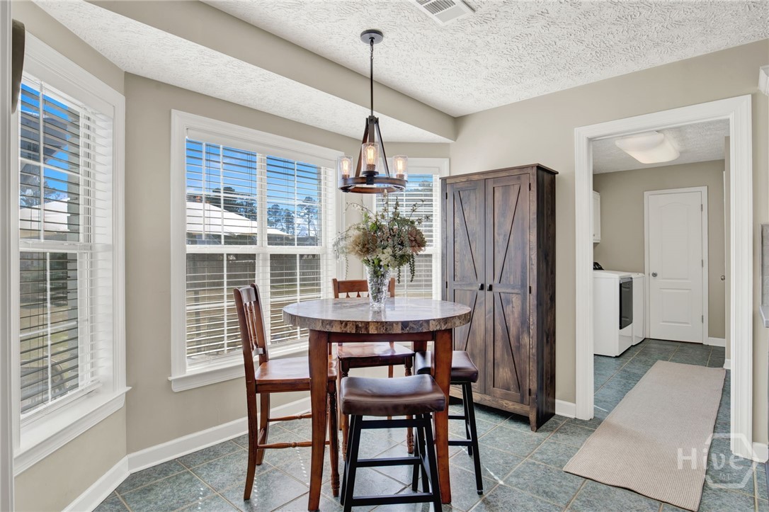 253 Scuffletown Road Guyton, GA 31312 - Photo 24 of 37 Bright breakfast nook with bay windows and easy access to the kitchen and laundry room.