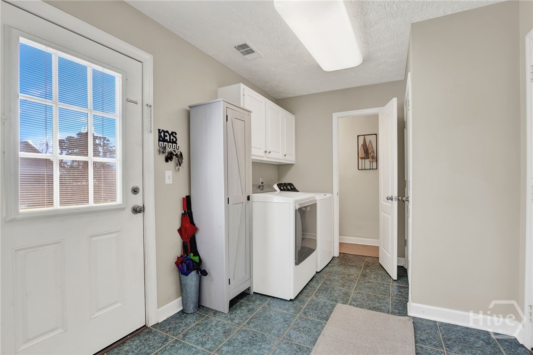 253 Scuffletown Road Guyton, GA 31312 - Photo 26 of 37 Functional laundry room with exterior access and additional storage space.