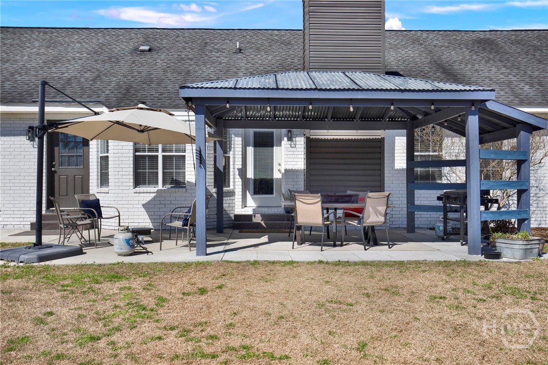253 Scuffletown Road Guyton, GA 31312 - Photo 29 of 37 Covered patio with pergola and outdoor dining area, perfect for entertaining.