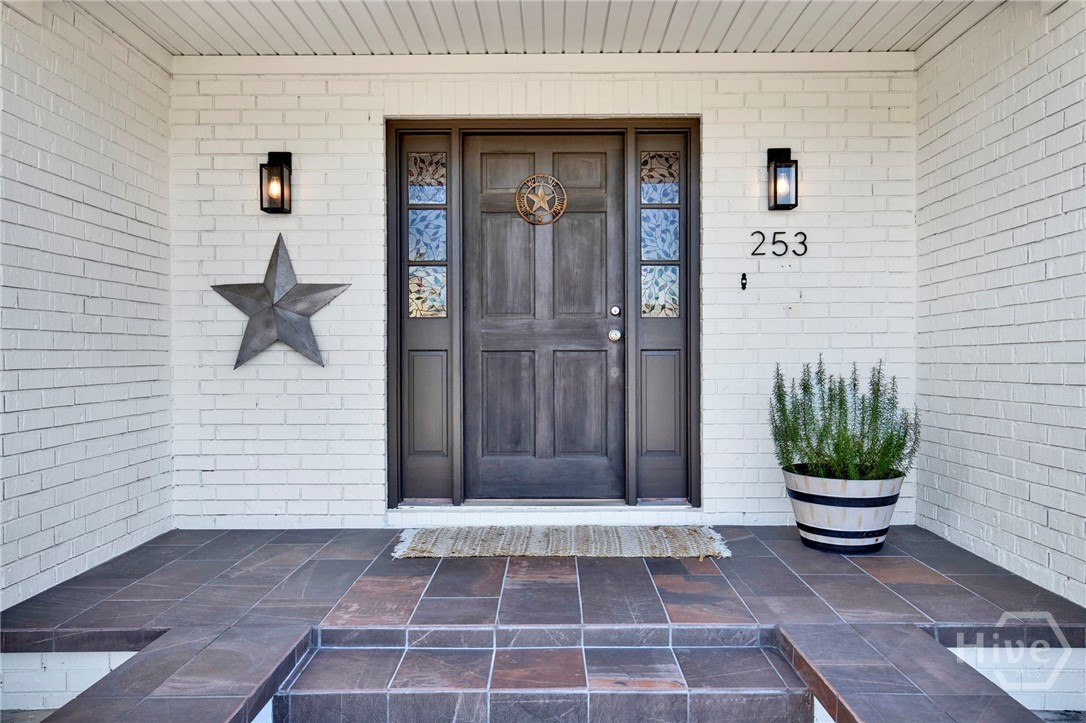 253 Scuffletown Road Guyton, GA 31312 - Photo 5 of 37 Inviting covered entry with a statement front door and classic brick exterior details.