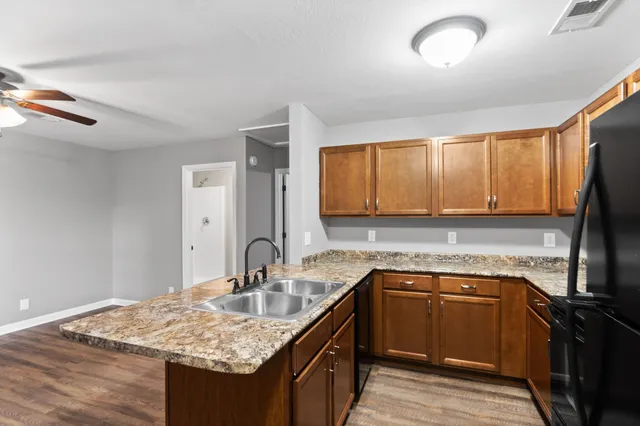 a kitchen with a sink stove and cabinets
