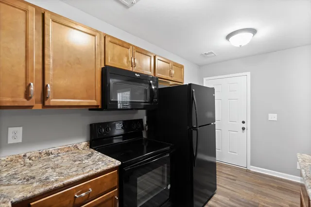 a kitchen with a refrigerator and a stove