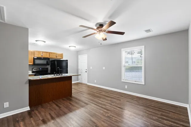 a view of kitchen with wooden floor and window