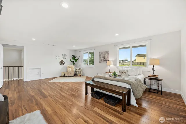 a bedroom with a bed and wooden floor