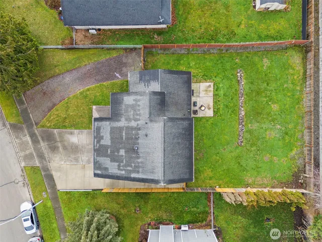 an aerial view of a house with a yard