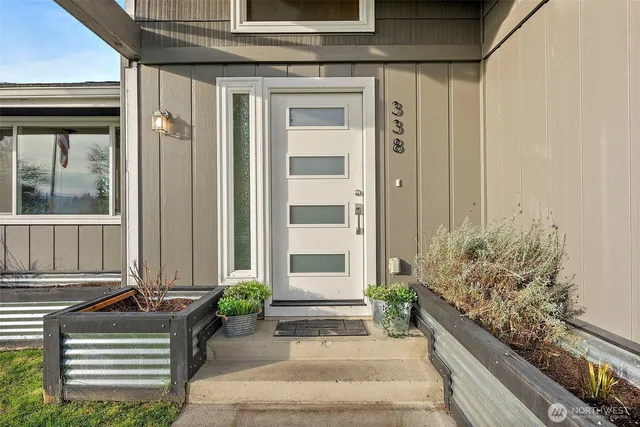 a front view of a house with a garden
