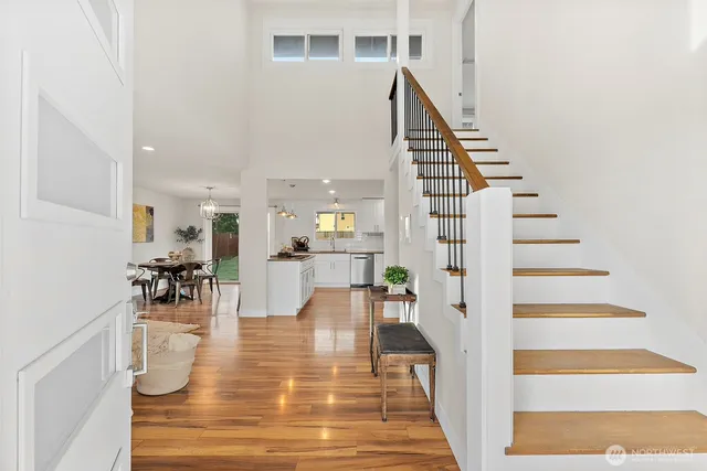 a view of entryway and hall with wooden floor