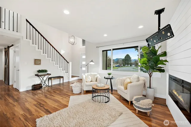 a living room with furniture fireplace and a potted plant