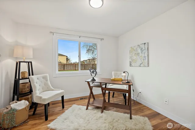 a work room with furniture and a window