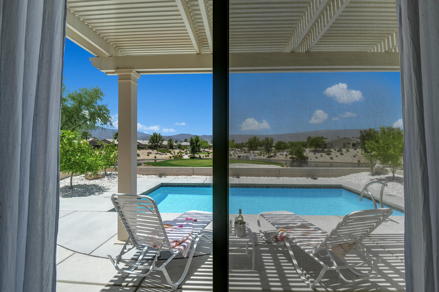81881 Avenida Estuco Indio, CA 92203 - Photo 18 of 33 a balcony with table and chairs and potted plants