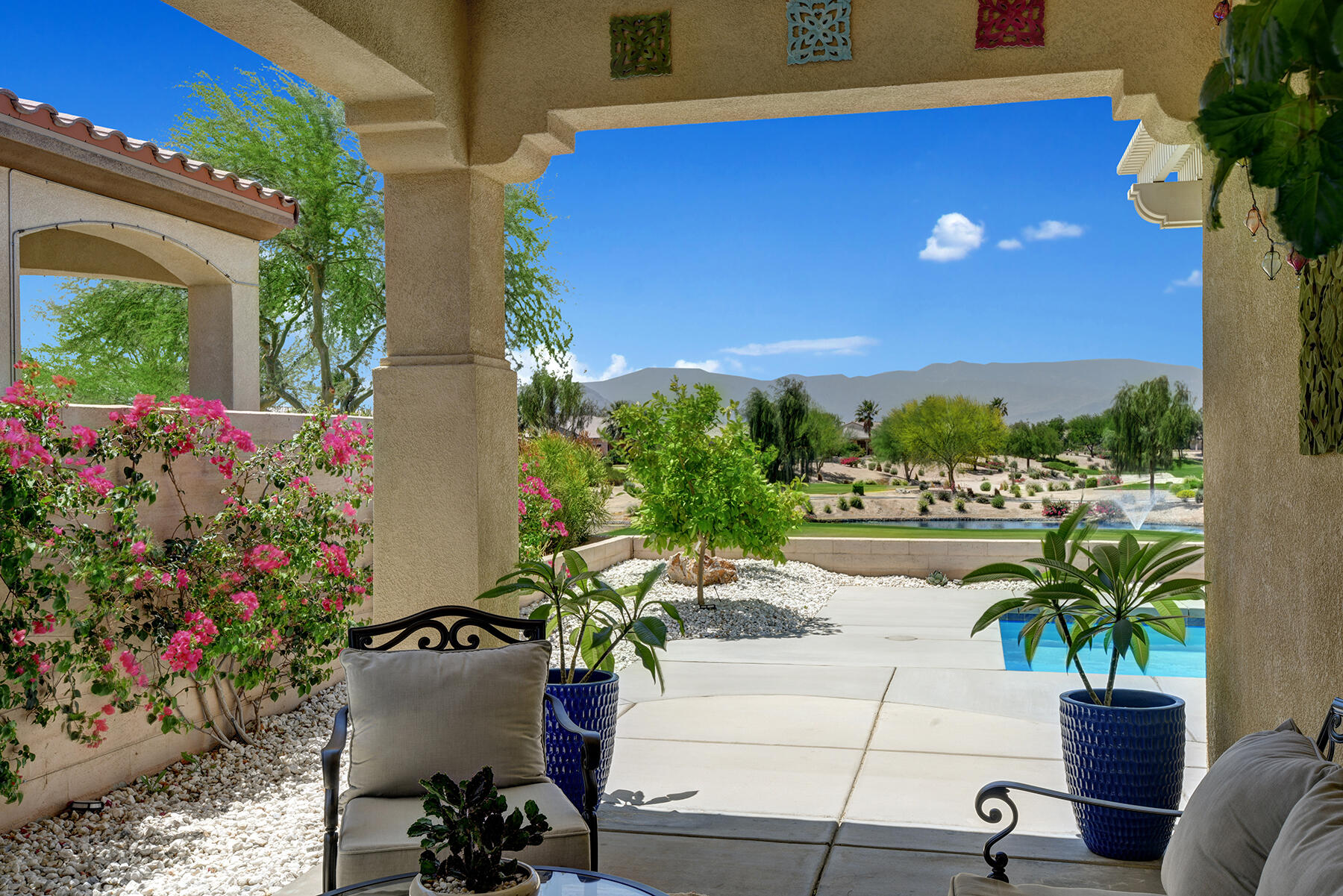 81881 Avenida Estuco Indio, CA 92203 - Photo 28 of 33 a view of a patio with plants and table and chairs