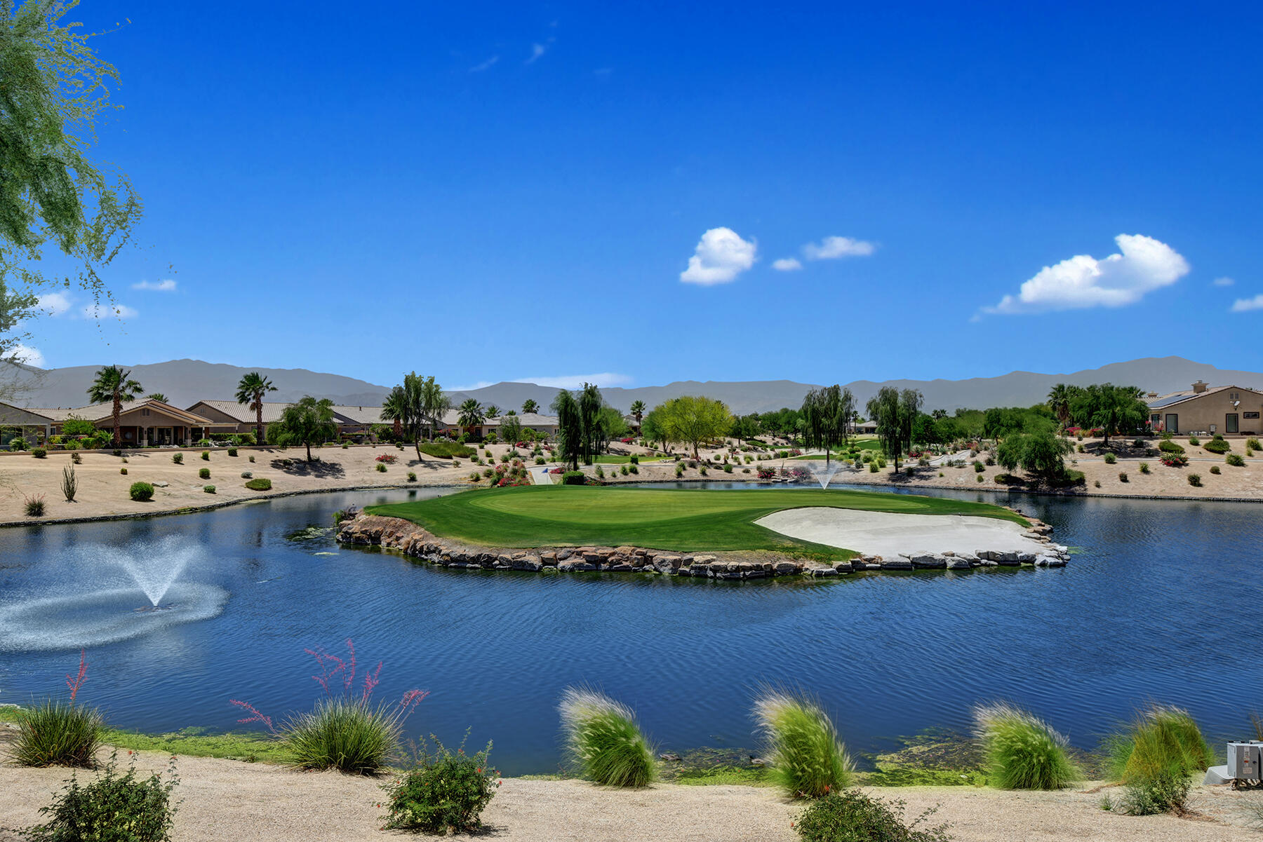 81881 Avenida Estuco Indio, CA 92203 - Photo 33 of 33 a view of a lake with a house in the background