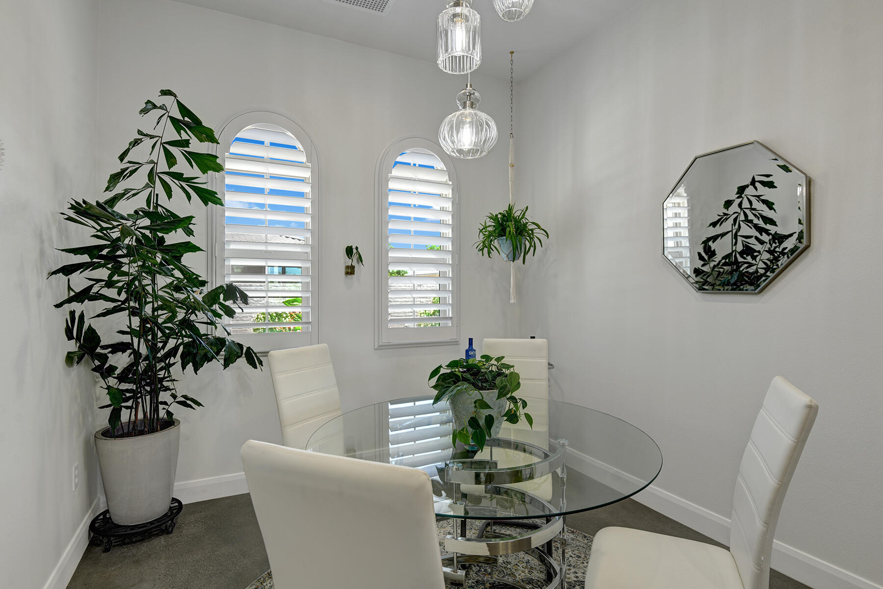 81881 Avenida Estuco Indio, CA 92203 - Photo 9 of 33 a dining room with furniture a potted plant and wooden floor