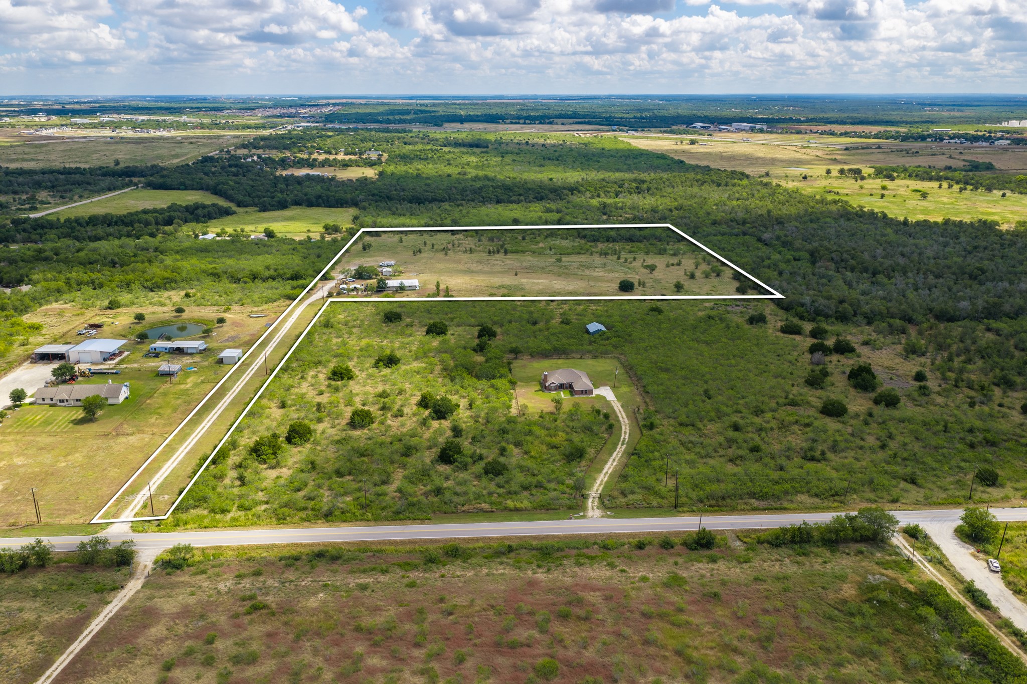 8804 Williamson Road Buda, TX 78610 - Photo 33 of 37 Gentle topography and mature trees define this expansive acreage under wide open Texas skies.