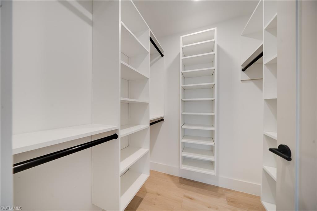 3695 El Segundo Court Naples, FL 34109 - Photo 11 of 37 Walk in closet featuring light wood-type flooring