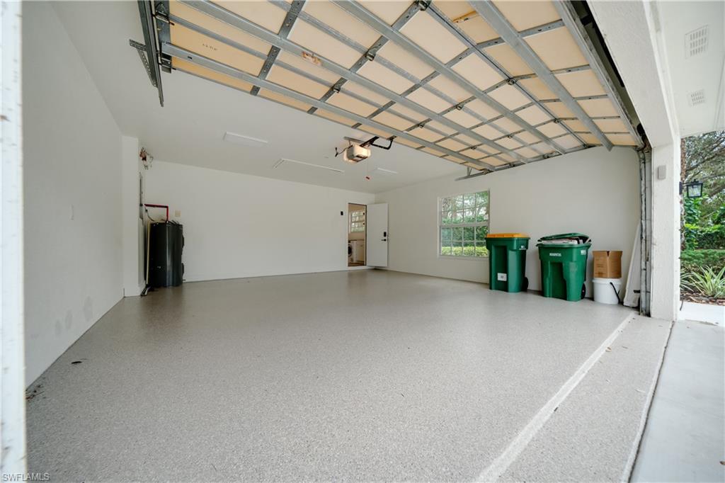 3695 El Segundo Court Naples, FL 34109 - Photo 32 of 37 Garage with a garage door opener and electric water heater