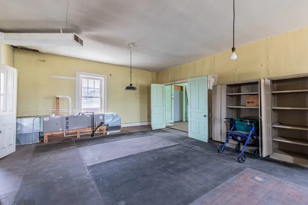 a view of a room with wooden floor