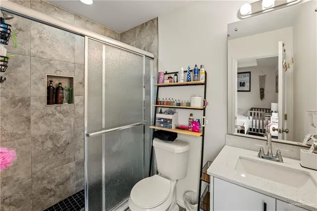 a white toilet sitting next to a bathroom sink