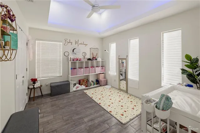 a bedroom with furniture and a large window