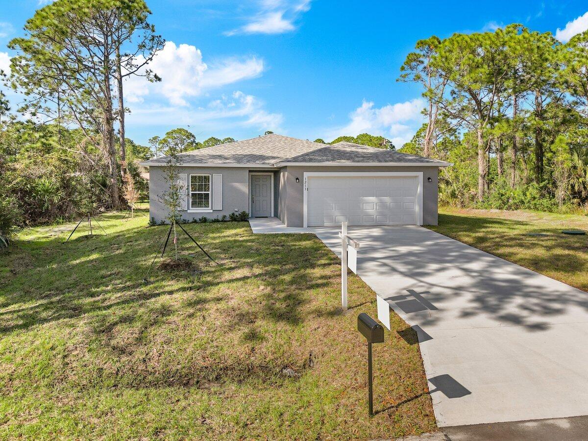 1213 Ragen Road Southeast Palm Bay, FL 32909 - Photo 1 of 26 a view of a house with a yard