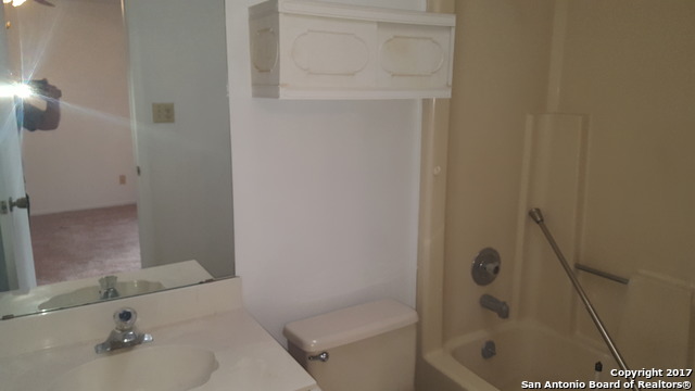 320 Station Street, Unit 101 Converse, TX 78109 - Photo 13 of 14 a bathroom with a sink and a mirror