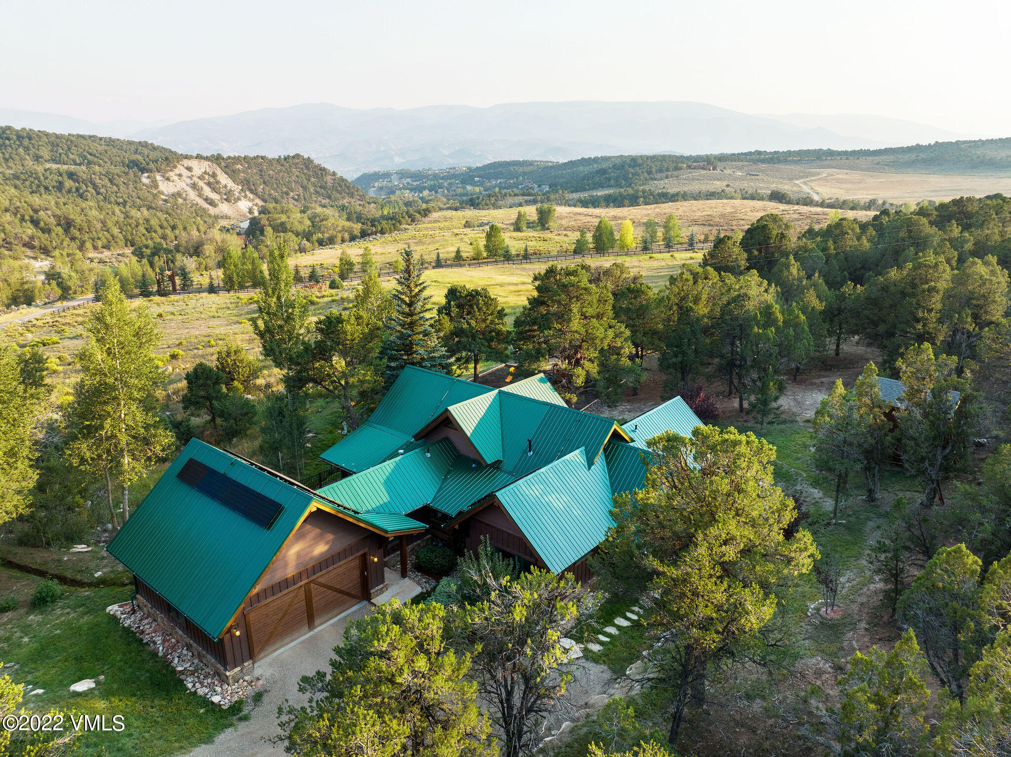 an aerial view of residential houses with outdoor space and swimming pool