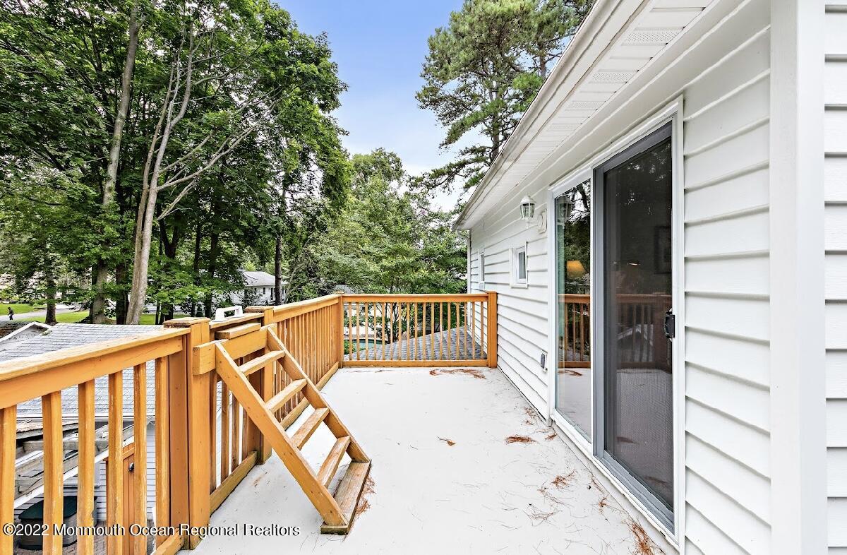 214 Cliftwood Road Oakhurst, NJ 07755 - Photo 17 of 61 a view of a balcony with wooden floor and fence
