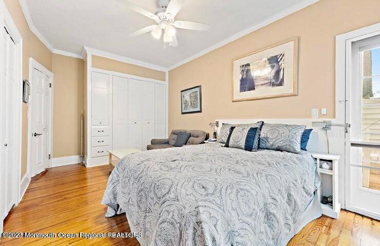 214 Cliftwood Road Oakhurst, NJ 07755 - Photo 18 of 61 a spacious bedroom with a bed and a chandelier