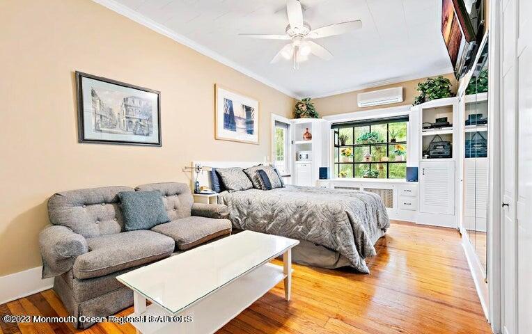 214 Cliftwood Road Oakhurst, NJ 07755 - Photo 19 of 61 a spacious bedroom with a bed a couch and a window
