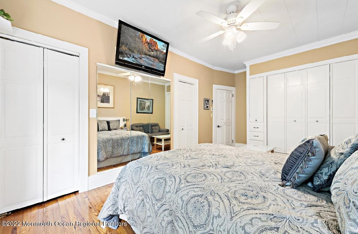 214 Cliftwood Road Oakhurst, NJ 07755 - Photo 21 of 61 a bedroom with a bed and a chandelier