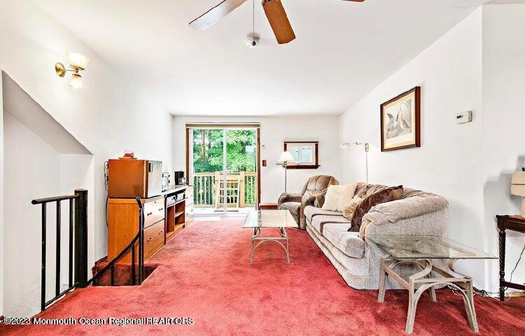 214 Cliftwood Road Oakhurst, NJ 07755 - Photo 25 of 61 a living room with furniture gym equipment and a large window