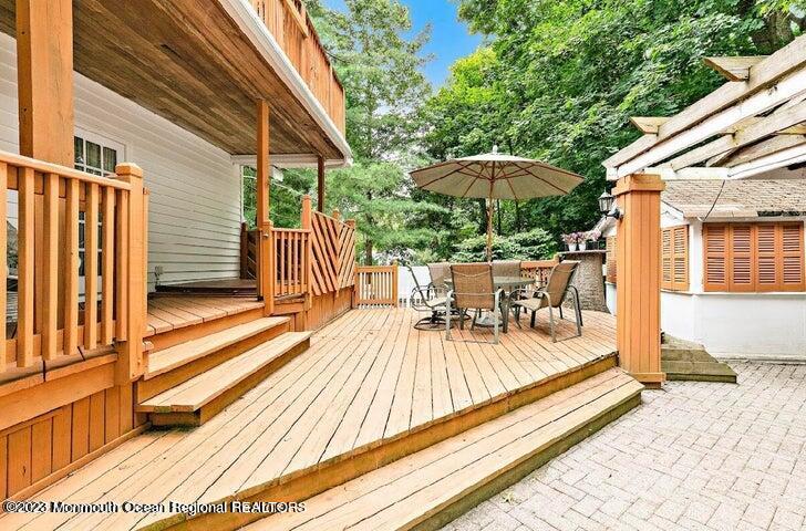 214 Cliftwood Road Oakhurst, NJ 07755 - Photo 32 of 61 a view of a patio with a table and chairs