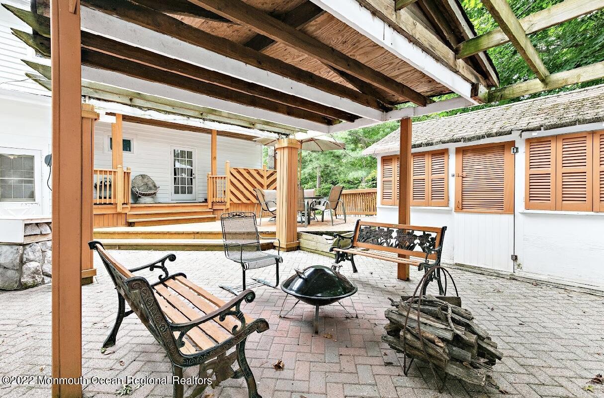 214 Cliftwood Road Oakhurst, NJ 07755 - Photo 48 of 61 a outdoor space with patio the couches and a dining table with chairs