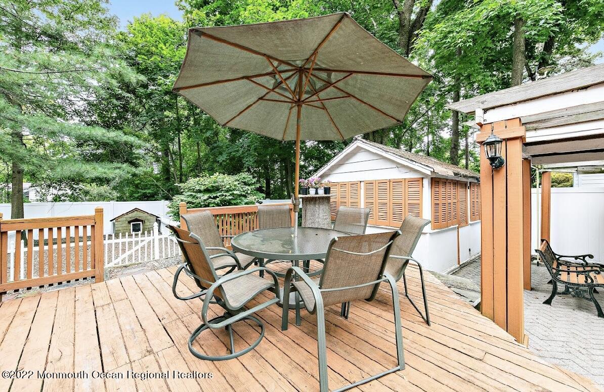 214 Cliftwood Road Oakhurst, NJ 07755 - Photo 49 of 61 a view of a roof deck with table and chairs under an umbrella