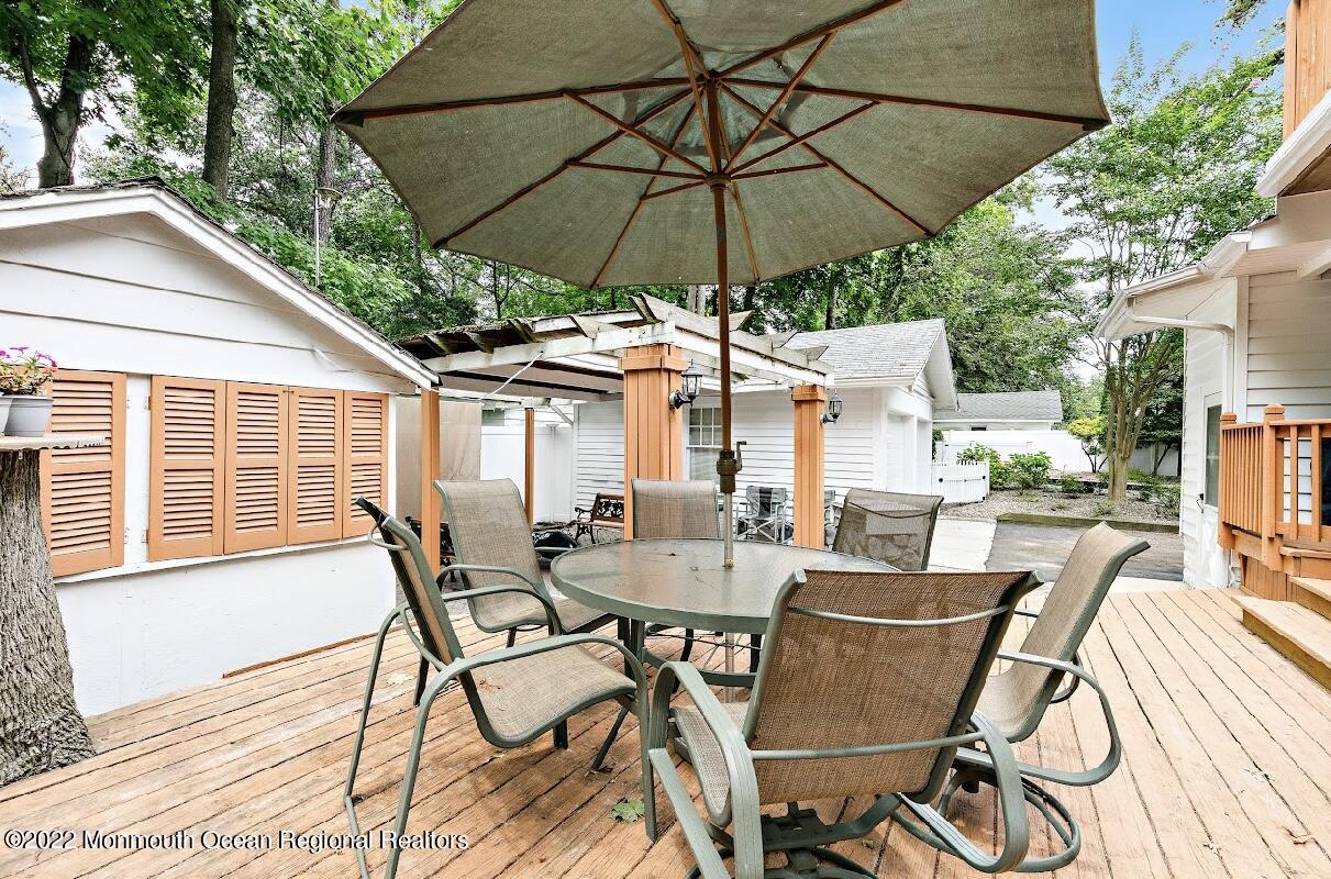 214 Cliftwood Road Oakhurst, NJ 07755 - Photo 50 of 61 a view of a patio with chairs and table under an umbrella with a barbeque