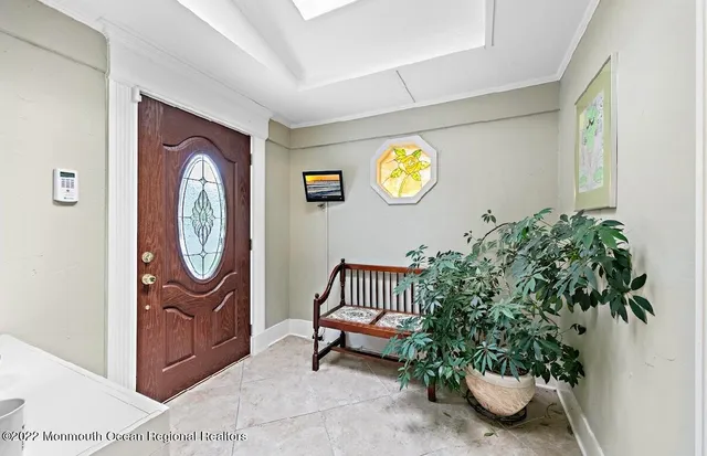a living room with furniture flat screen tv and a large window
