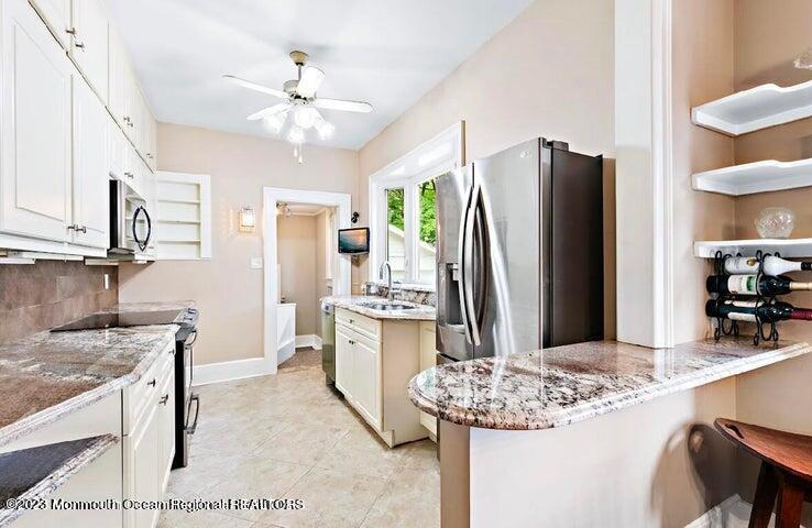214 Cliftwood Road Oakhurst, NJ 07755 - Photo 10 of 61 a kitchen with stainless steel appliances granite countertop a sink stove and refrigerator